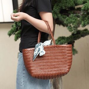Hand-woven dark brown handbag with a removable drawstring pouch inside
